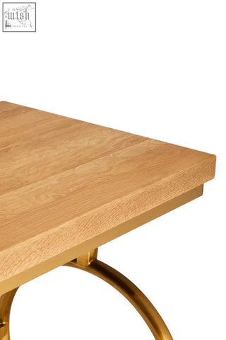 A jarloi console table with a square light oak wooden top and elegant gold-toned metal legs