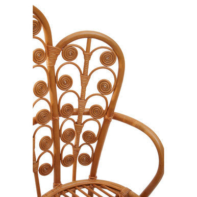 A light brown java natural rattan scalloped back chair with intricate spiral and fan-shaped woven patterns