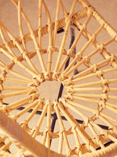 Natural woven java rattan chair with sunburst pattern and black metal frame perfect for indoor seating