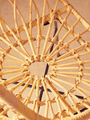 Natural woven java rattan chair with sunburst pattern and black metal frame perfect for indoor seating
