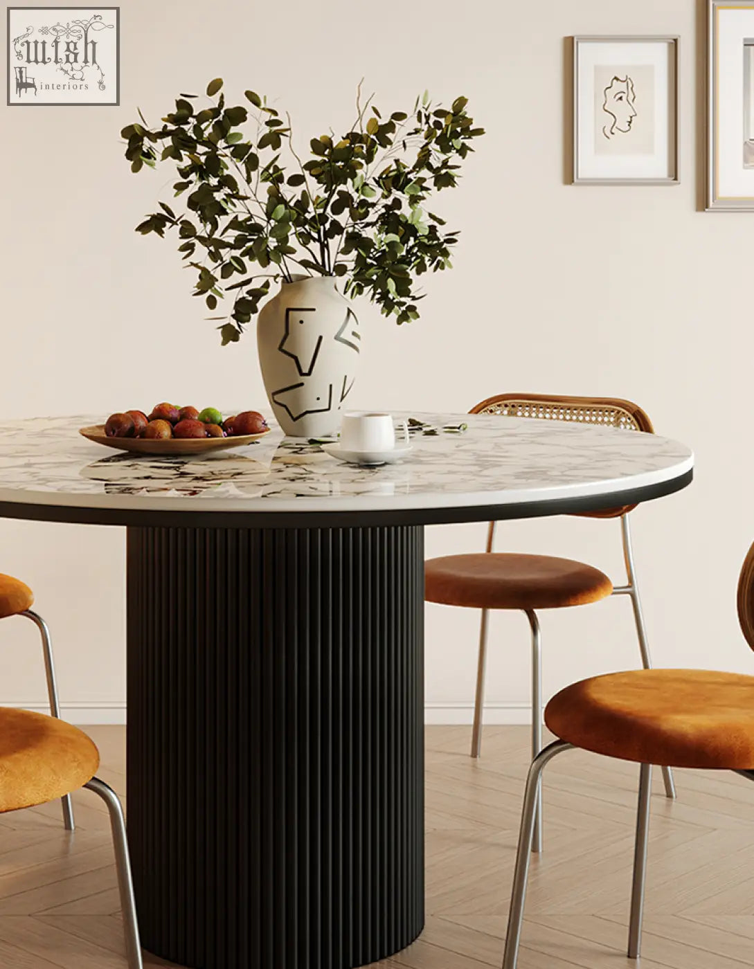 White ceramic vase with black geometric patterns and green leaves on a white and black jean round dining table
