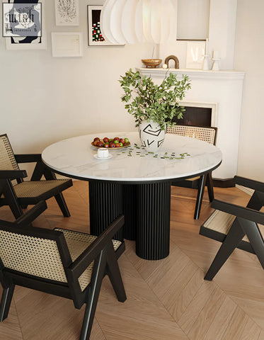Jean round dining table with white marble top and black ribbed pedestal base for stylish round dining