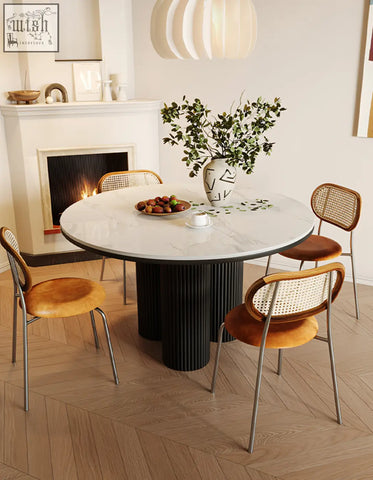 Jean round dining table with white marble top and black ribbed pedestal base perfect for round dining spaces