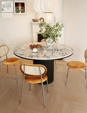 Jean round dining table with white marble top and black ribbed pedestal base perfect for round dining spaces
