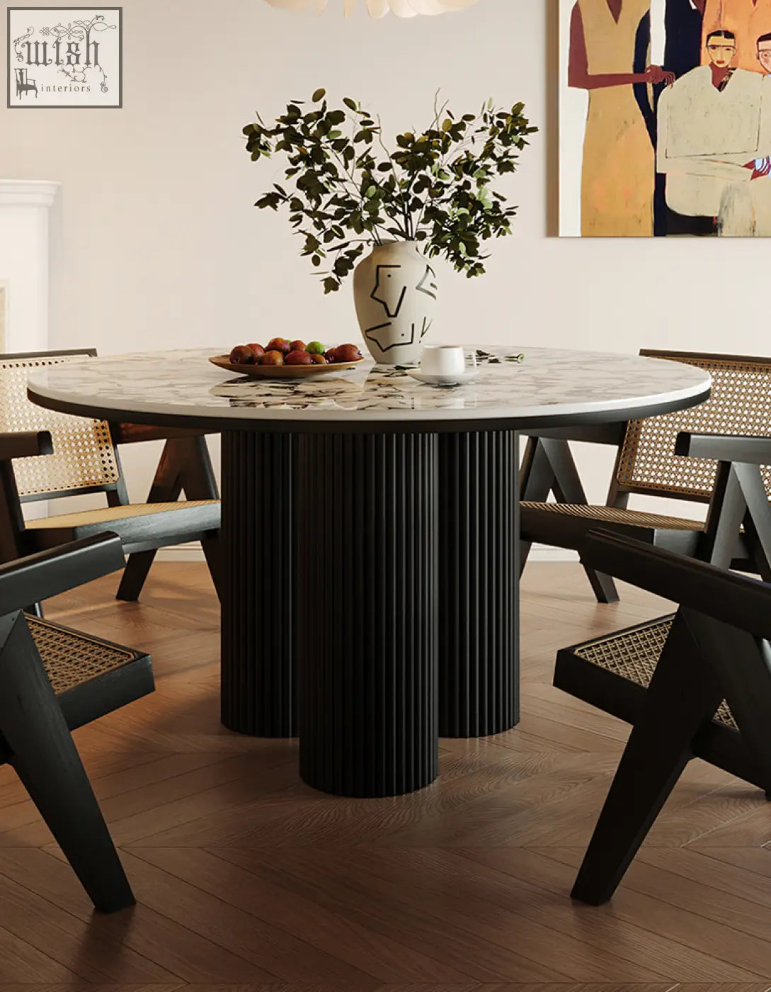 Round marble-top dining table with black ribbed cylindrical legs perfect for stylish round dining spaces