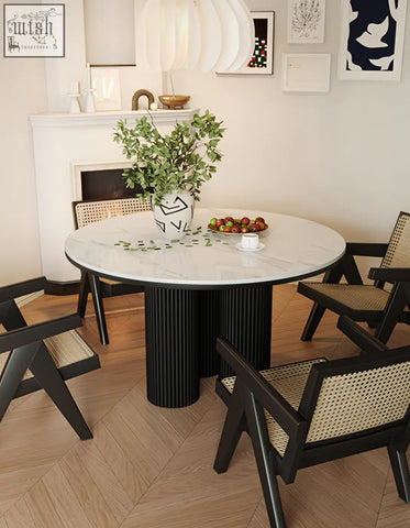 Jean round dining table with white marble top and black ribbed pedestal base ideal for round dining spaces