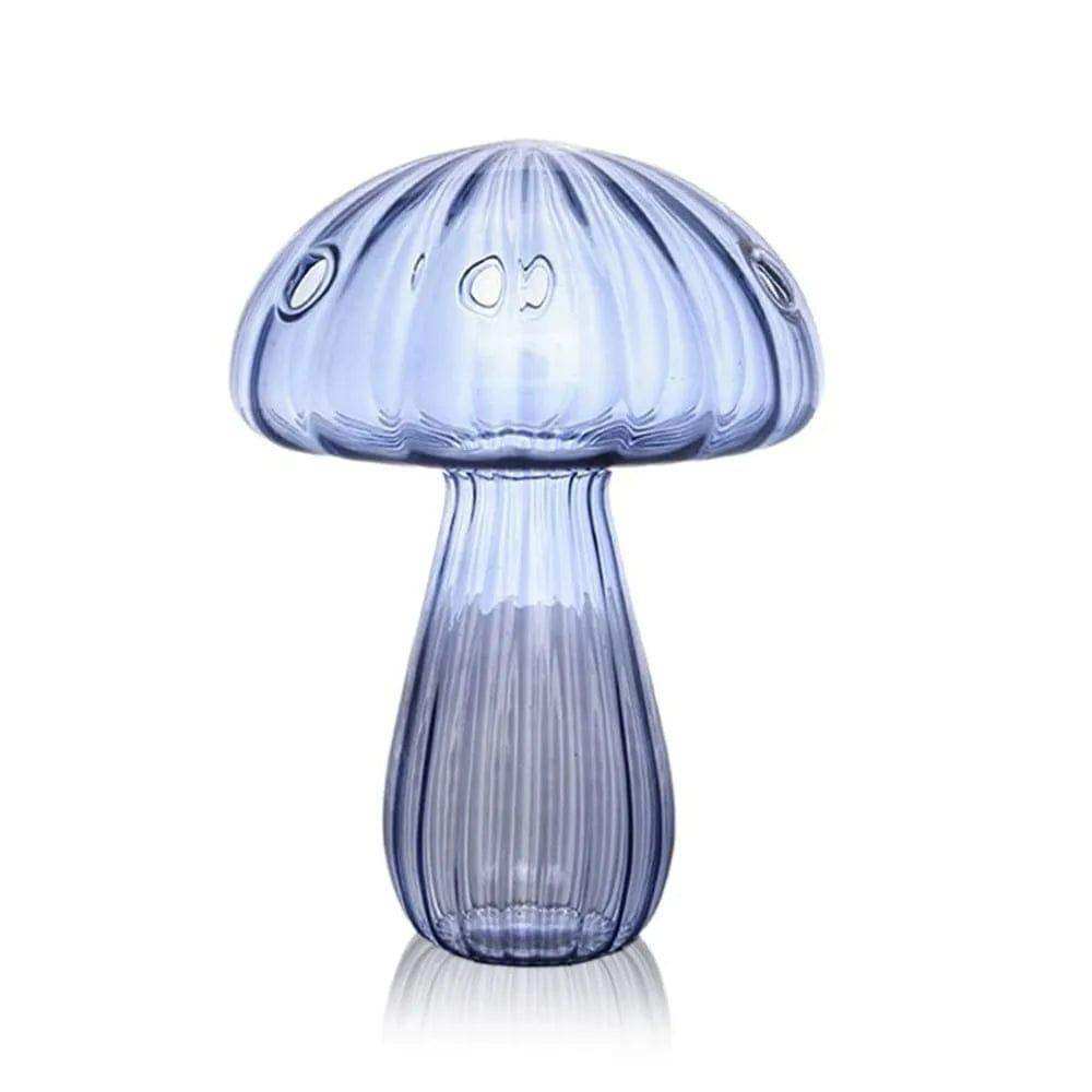 A translucent blue glass jelly mushroom vase with vertical ridges and three small circular cutouts on its cap