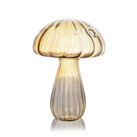 A translucent amber glass jelly mushroom vase with vertical ribbed texture and subtle golden to clear gradient