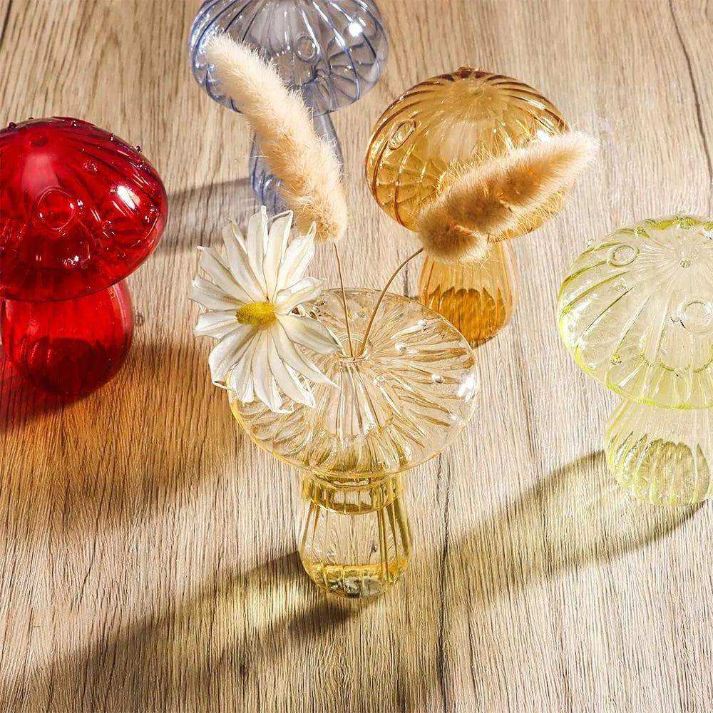 Clear glass jelly mushroom vase with textured ribbed design holding a small white daisy flower inside