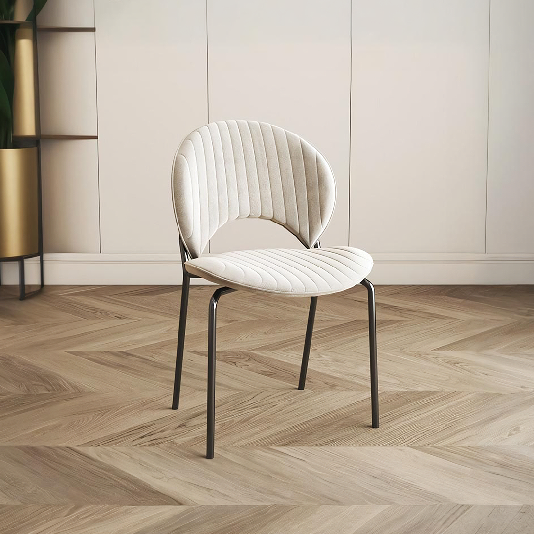 Cream-colored quilted velvet jerome dining chair with sleek black metal frame perfect for dining room seating