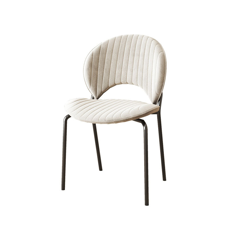 Cream-colored velvet jerome dining chair with ribbed back and seat on sleek black metal legs for dining use