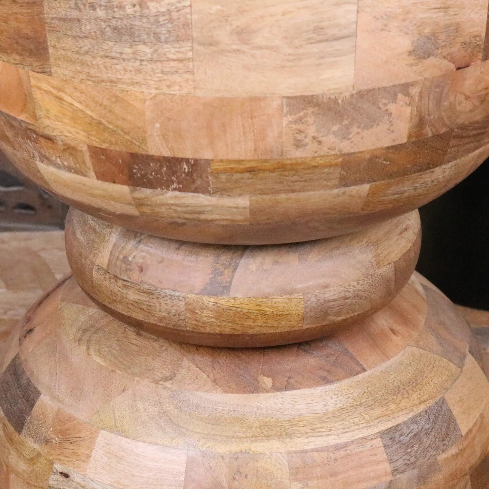 A jivana mango wood side table with a rustic patchwork design made from reclaimed mango wood with natural tones