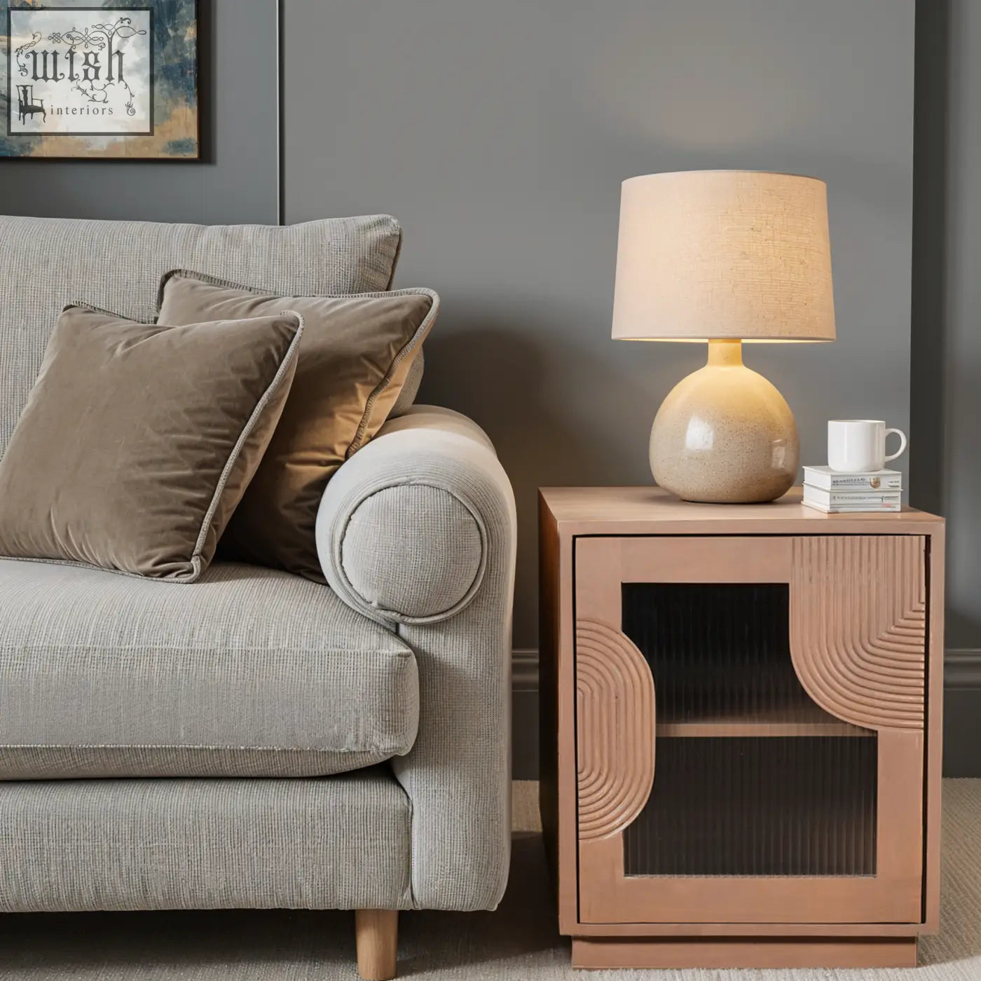 Beige ceramic table lamp with textured linen shade on jodhpur solid wood bedside table with pale taupe finish