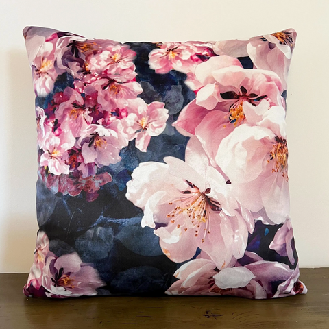 A high quality jolanda floral velvet cushion with pink and white blossoms on a deep navy floral velvet background