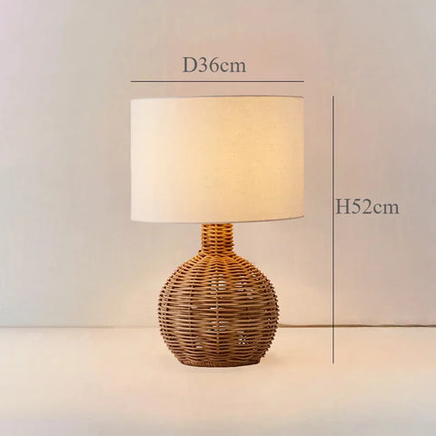 Jolano light rattan table lamp with warm tones and a cylindrical off-white fabric shade for cozy lighting