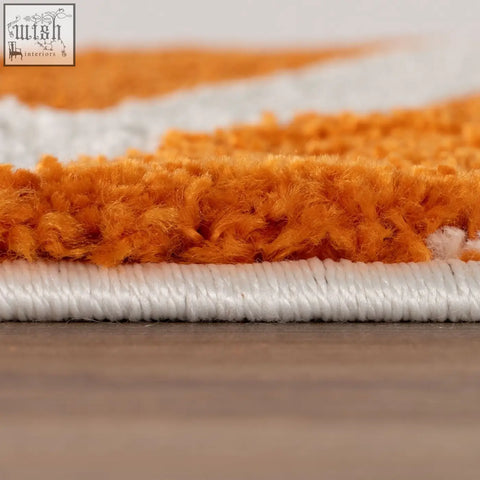 Plush textured orange and white rug featuring a joli checkered orange striped pattern for cozy decor