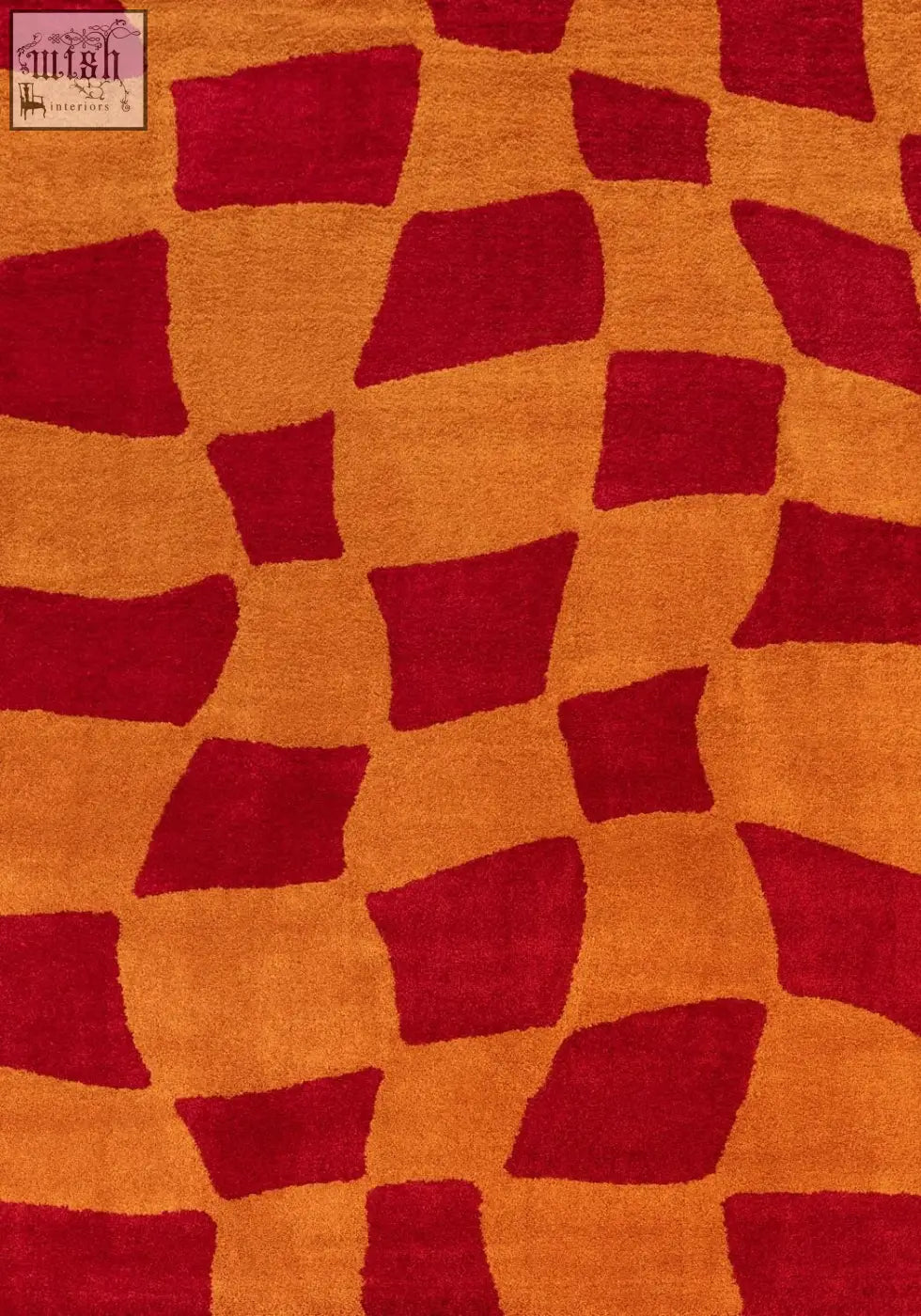 A plush orange and deep red geometric patterned rug featuring irregular blocks called joli checkered red and orange rug