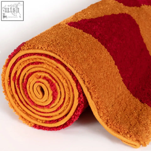 A plush rolled joli checkered red and orange rug with a fluffy textured surface perfect for cozy spaces