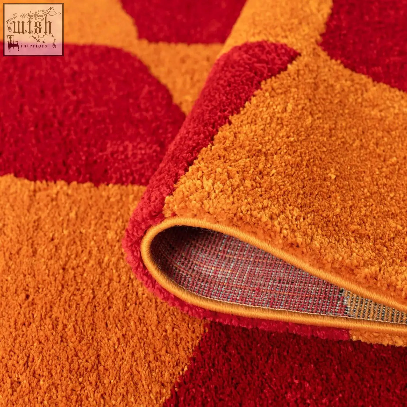 Vibrant orange and red geometric patterned plush rug with soft texture perfect for cozy living spaces joli checkered red