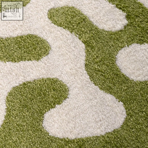A soft shaggy joli doodle green and white rug with an abstract plush pattern perfect for cozy spaces