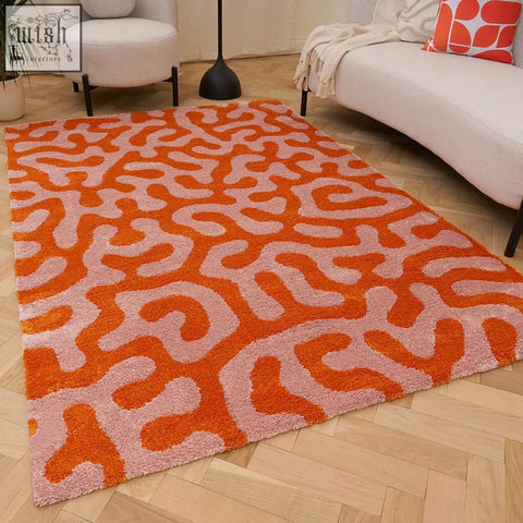 Vibrant orange and blush pink coral-inspired shag rug with plush texture in joli doodle orange style