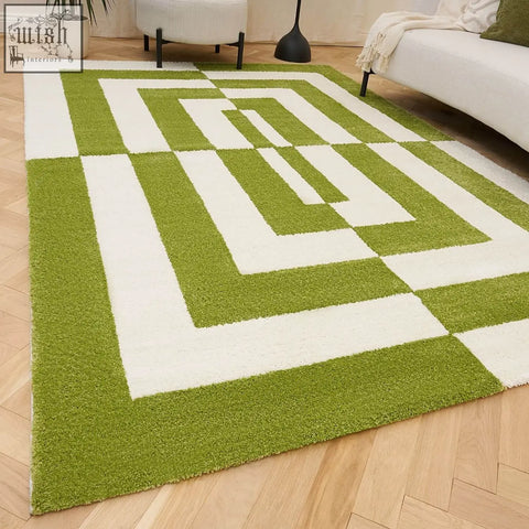 A plush green and white area rug with a modern abstract design from joli geometric green collection
