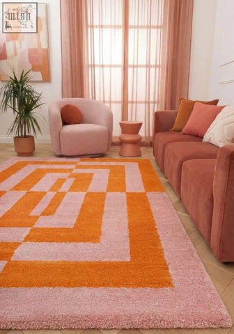 A plush joli geometric orange and pink rug with a shaggy texture and vibrant geometric pattern