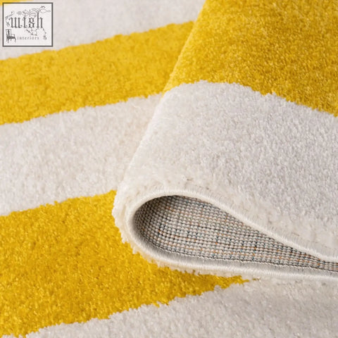 A plush joli geometric yellow and white rug with soft textured surface perfect for cozy living spaces