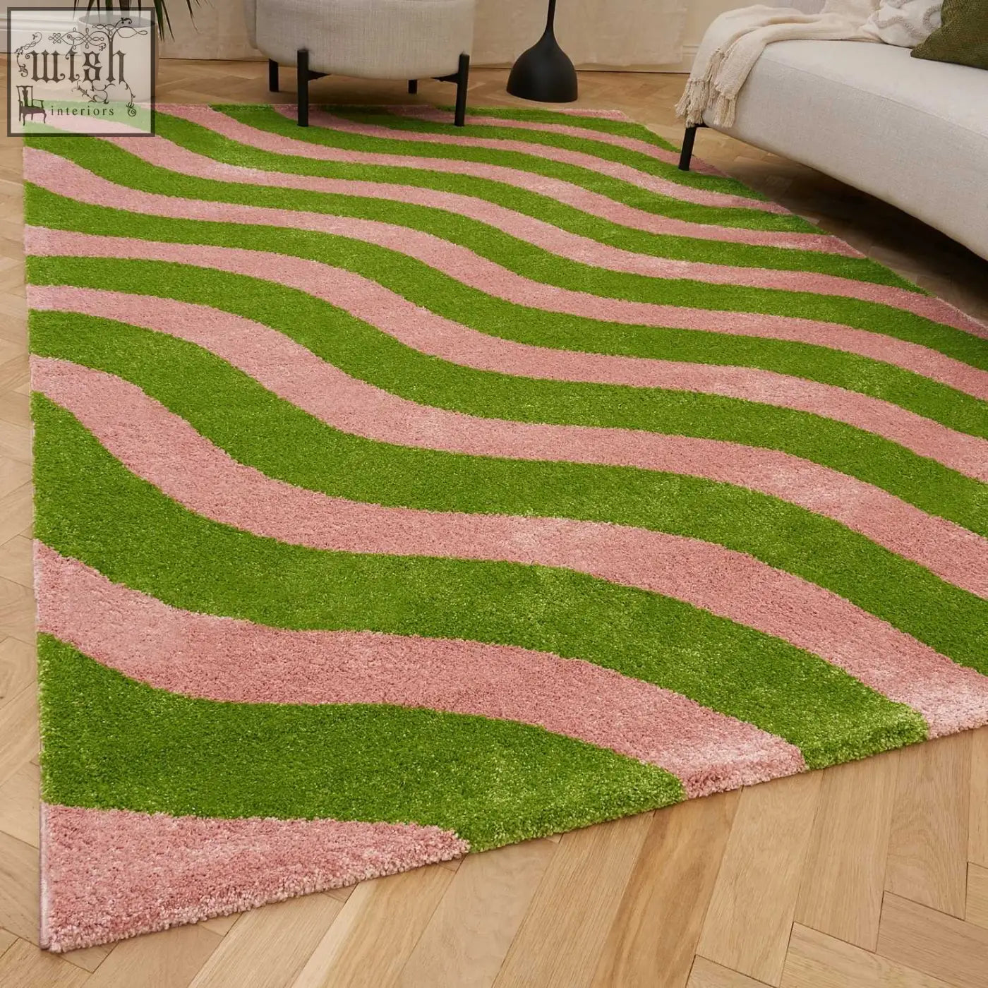 A plush rectangular joli wave green and pink rug with wavy stripes and a soft shaggy texture