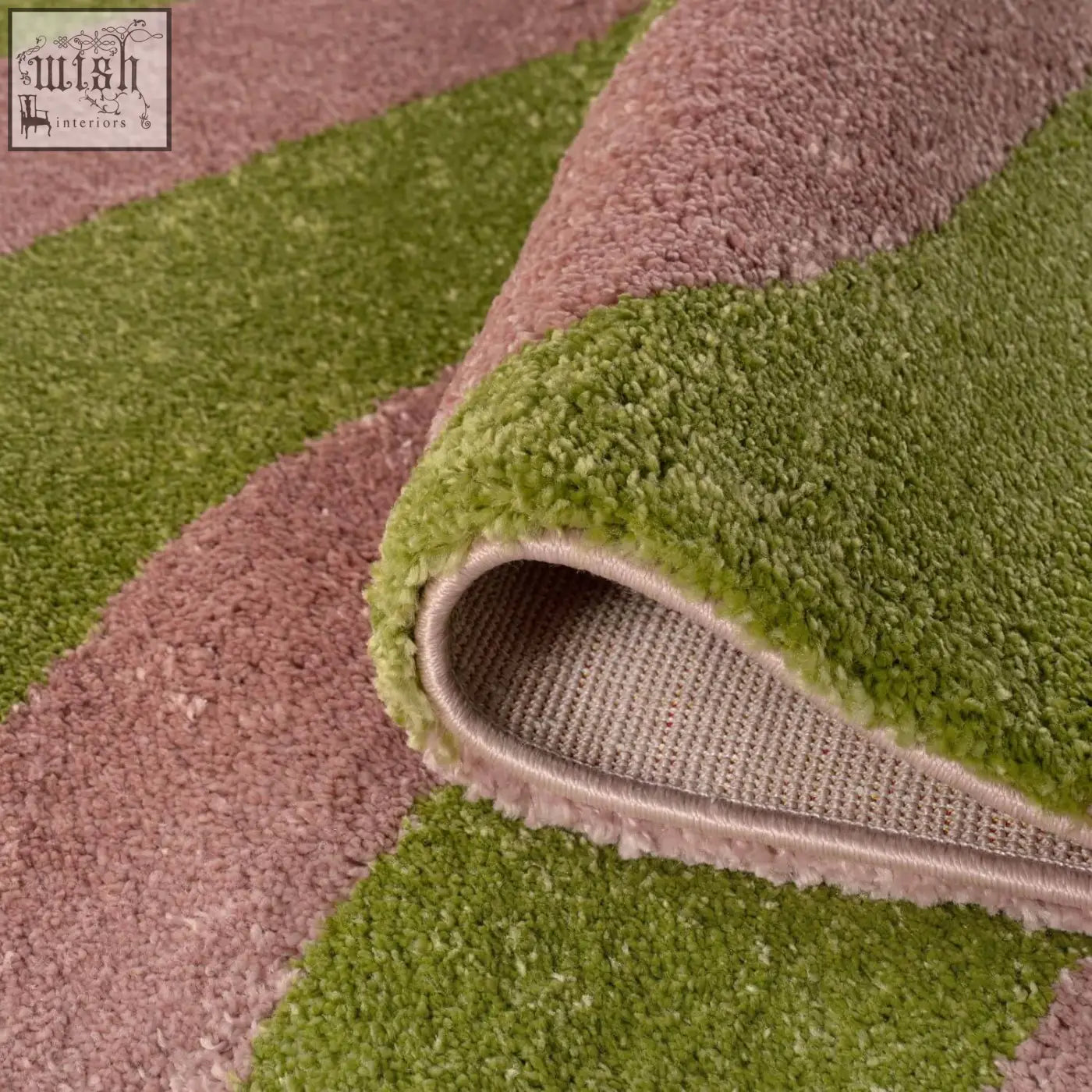 A plush soft textured joli wave green and pink rug with alternating olive green and dusty rose bands
