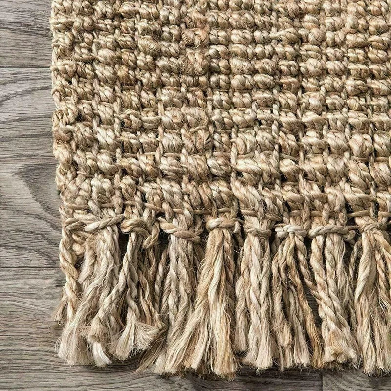 Natural fiber joto rug with textured woven pattern and fringed edges perfect for cozy living spaces