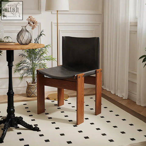Black leather judith dining chair with wooden legs showing seat and backrest for stylish dining seating