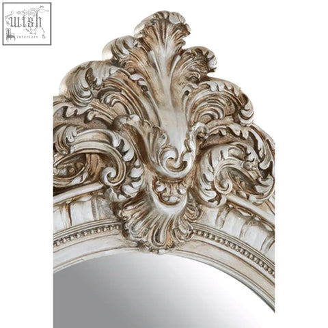 Antique-style silver champagne oval framed wall mirror with ornate scrollwork detailing for elegant decor
