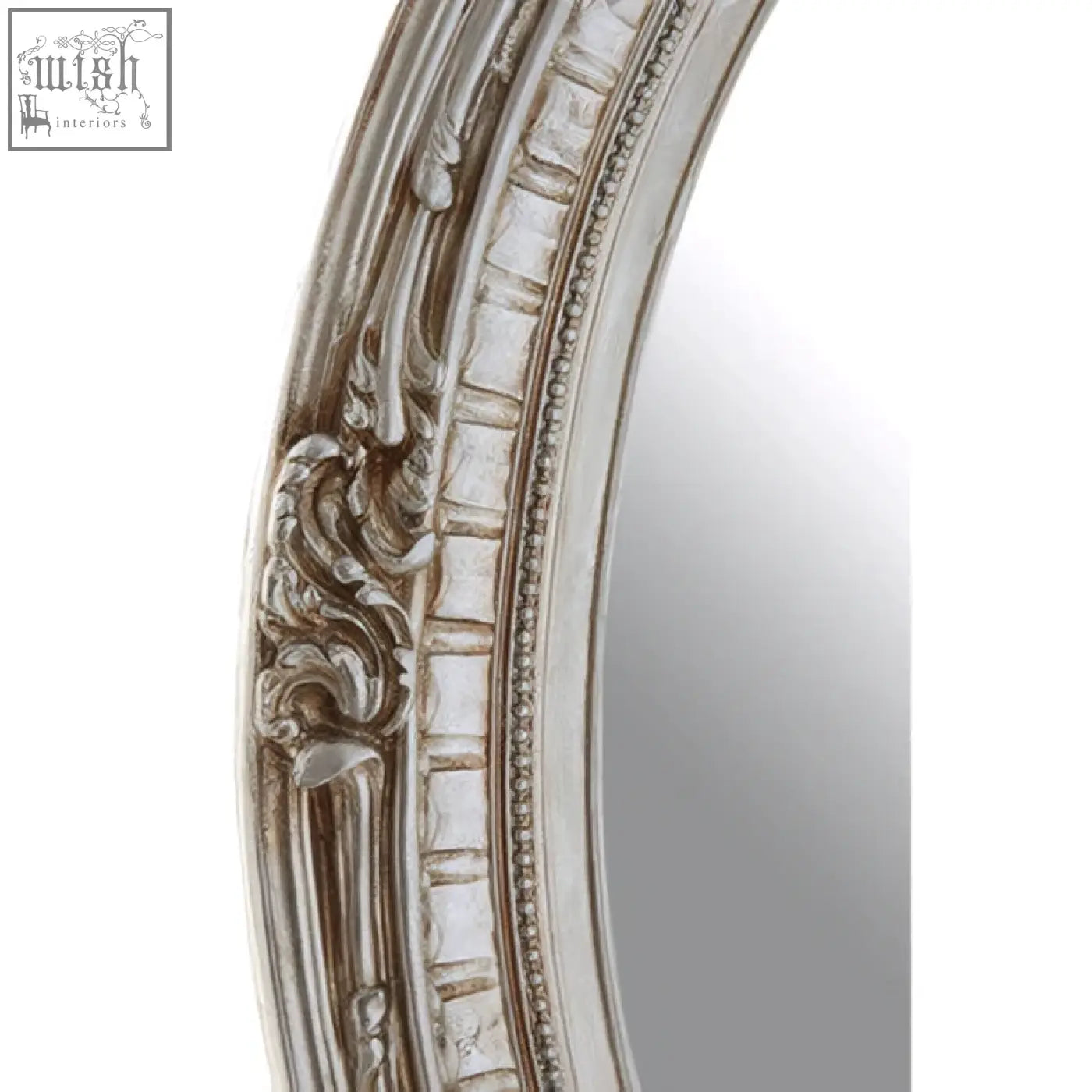 Silver champagne oval framed wall mirror with ornate carved detailing and distressed finish for elegant decor