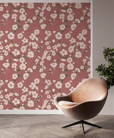 A sleek blush pink velvet egg-shaped armchair with a black metal base called junta perfect for cozy seating