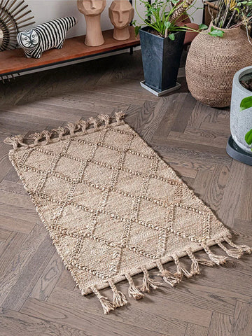 Beige woven junya rug with diamond pattern and tassels along edges for cozy living spaces