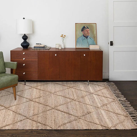 Beige woven jute junya rug with geometric diamond pattern and fringed edges perfect for cozy spaces