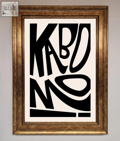 A kaboom framed print featuring bold black letterforms on white background in an ornate gold-toned frame