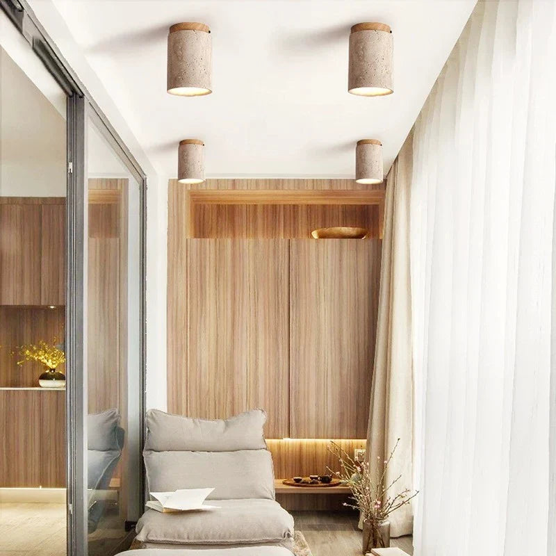 Four kaku light cylindrical ceiling lights with textured concrete exteriors and warm tone interiors