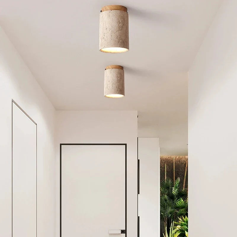 Cylindrical concrete kaku light ceiling fixture with natural wood top and warm diffused glow