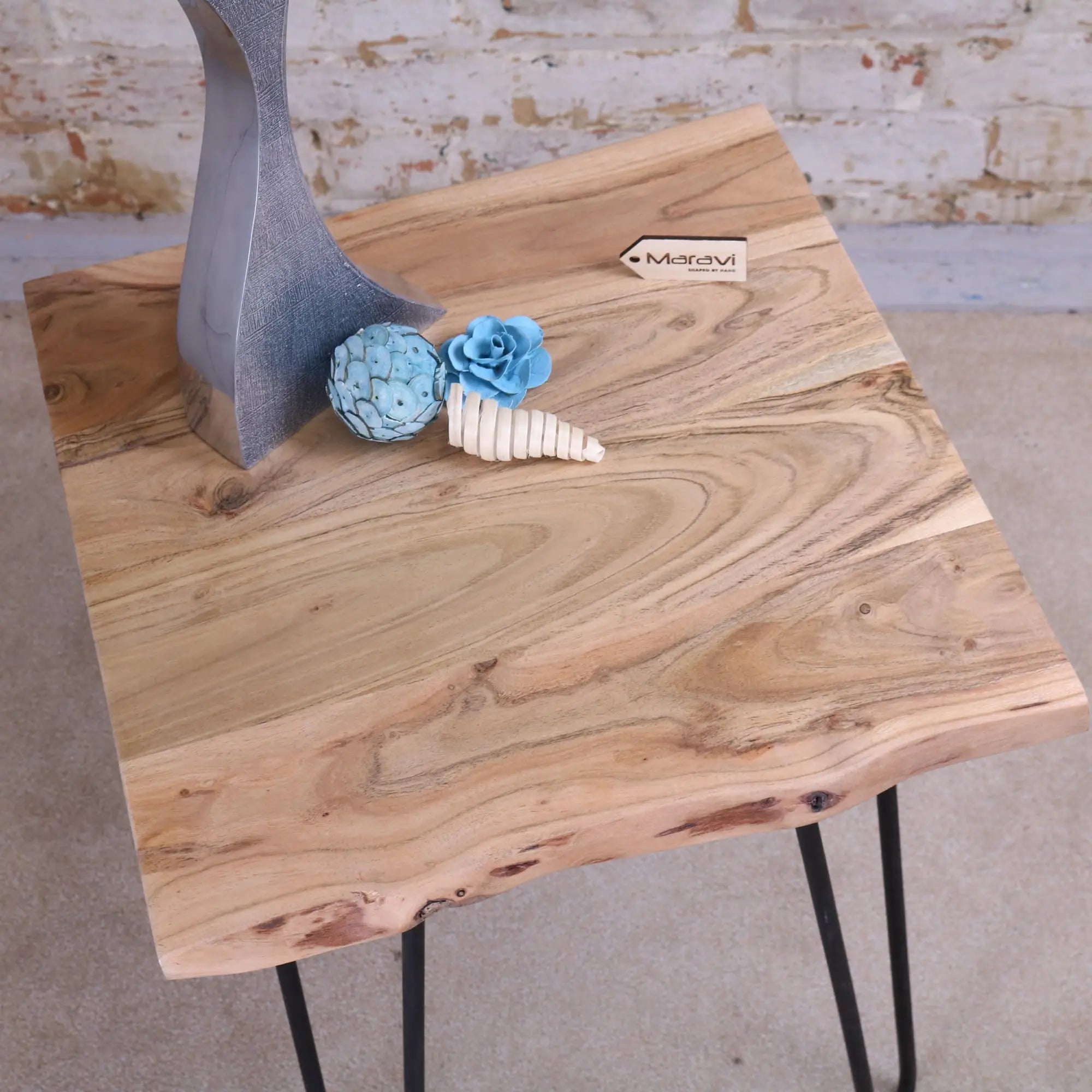 Light-colored kalan live edge wooden table with natural grain and black hairpin legs for stylish living spaces