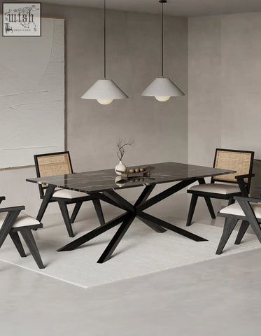 Kamara dining table with black marble top and sleek x-shaped metal base perfect for marble dining spaces