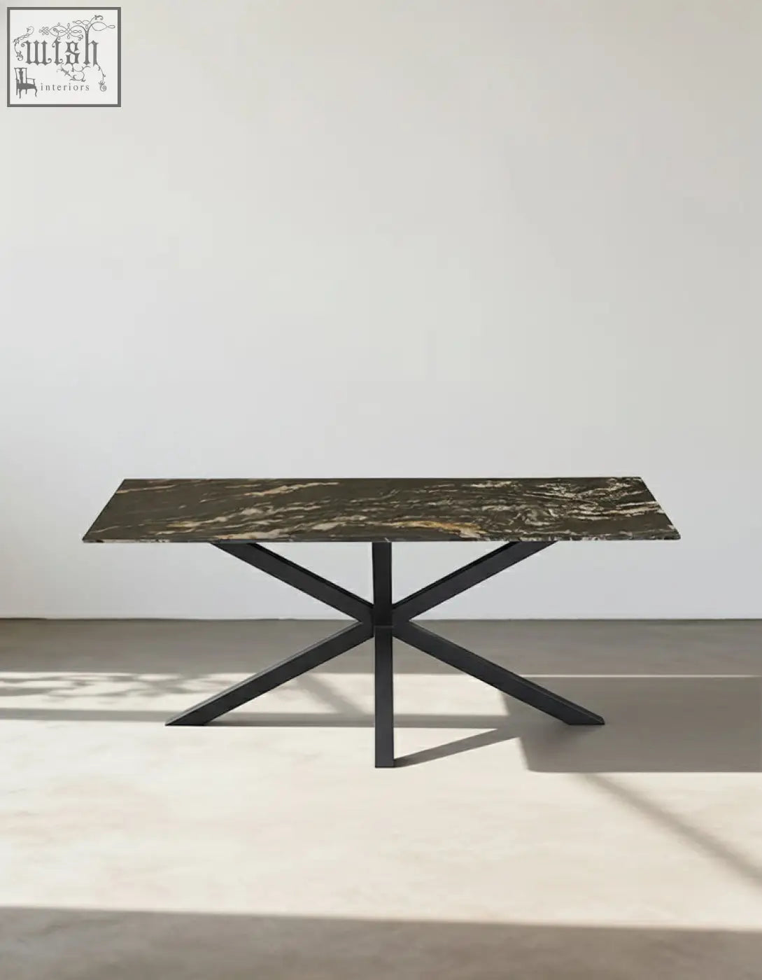 Kamara dining table with dark green and gold veined marble top and sleek black metal legs perfect as a marble dining table