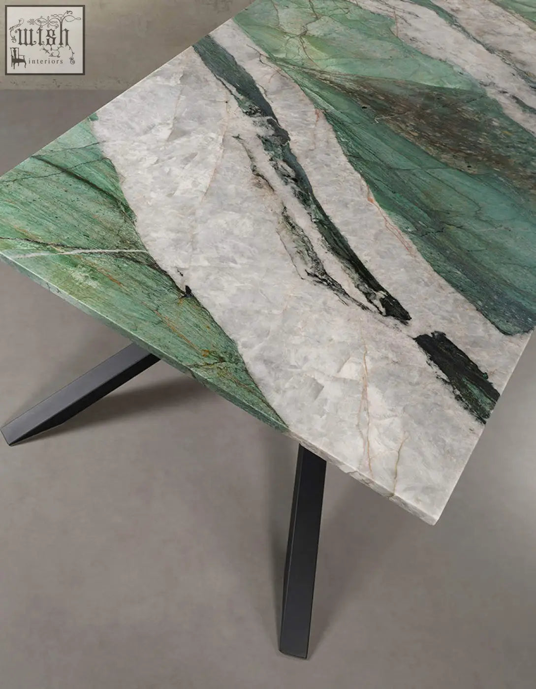 Kamara dining table with a polished green and white marble top and black metal legs perfect as a marble dining table