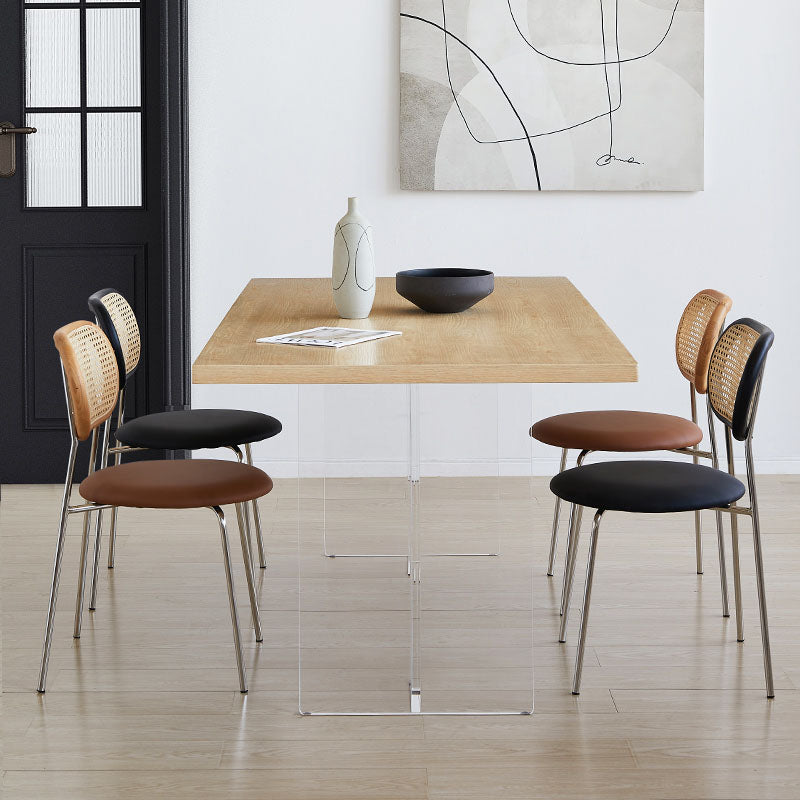 Modern dining chairs with woven cane backs, black and brown seats, and chrome legs paired with kamaria dining table solid wood