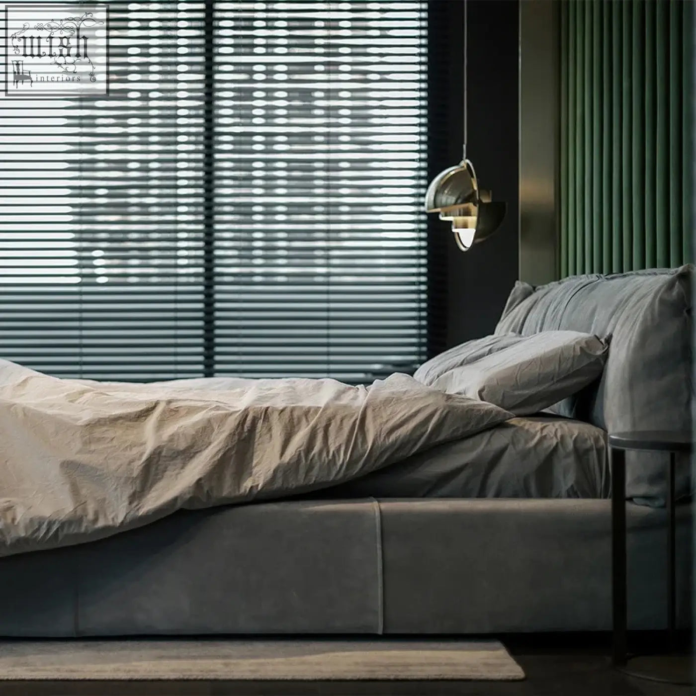 Kamoto bed with a sleek gray upholstered frame plush upholstery and a sturdy frame under soft beige linens