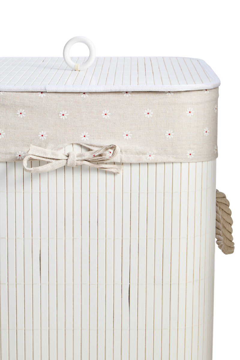 Beige woven laundry hamper with white floral trim and matching fabric bow in a kankyo white square design