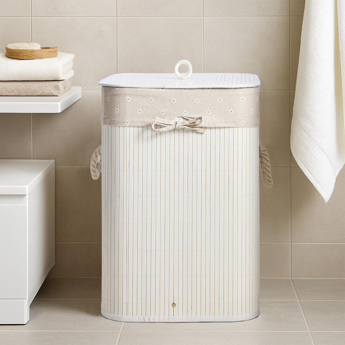 Kankyo white square laundry hamper in cream with ribbed texture, rope handles, and beige dotted decorative band with bow