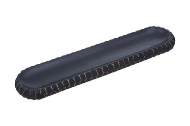Black leather phone stand with scalloped edges and stitched detailing next to kara black mango wood serving dish