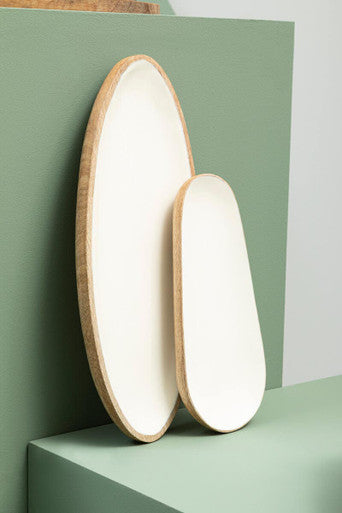 Two oval kara mango wood small serving dishes with matte white ceramic interior and natural wood grain edges